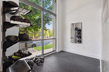 room with gym equipment and a window with a street view